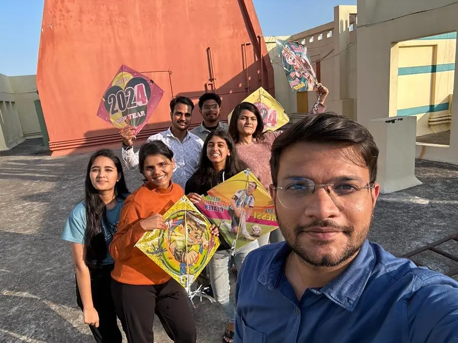 The team flying kites on a rooftop for Makar Sankranti