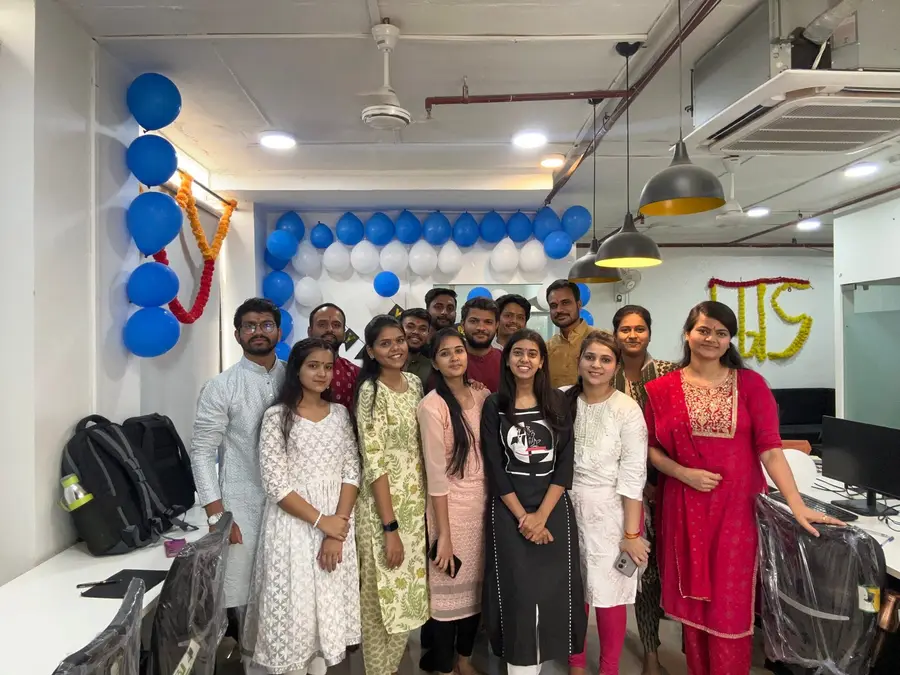 The AppWizards office decorated with balloons for a celebration, with the team lined up