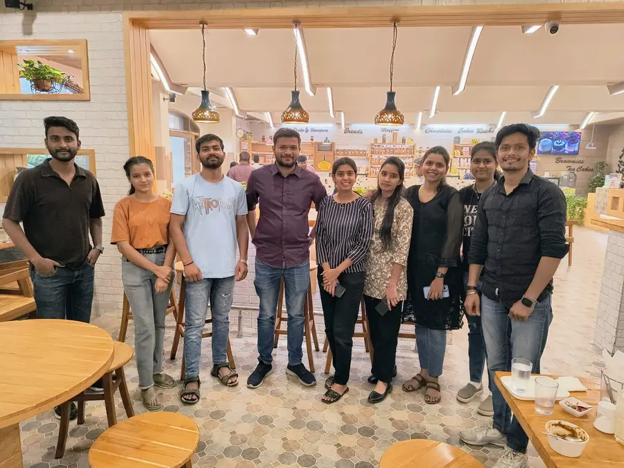 The AppWizards team standing together at a cafe during a team lunch