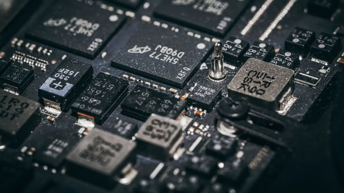A close-up of microchips on a dark circuit board.